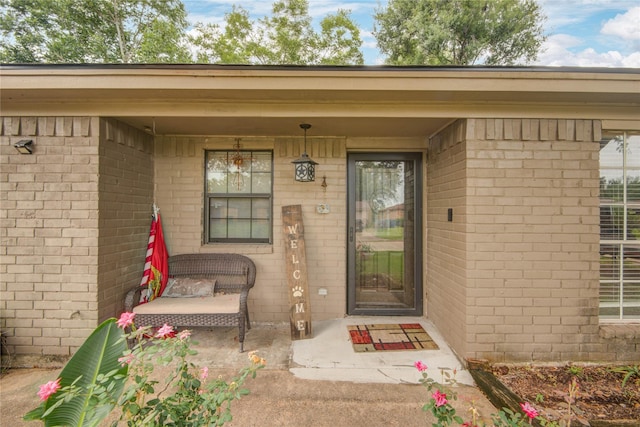 516 W Mimosa St, Angleton, TX 77515 - view of exterior entry featuring brick siding and covered porch