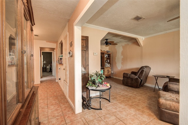 516 W Mimosa St, Angleton, TX 77515 - hallway featuring light tile patterned floors, a textured ceiling, and crown molding