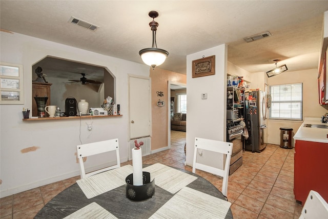 516 W Mimosa St, Angleton, TX 77515 - dining space with plenty of natural light, ceiling fan, and light tile patterned floors