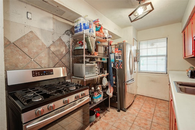 516 W Mimosa St, Angleton, TX 77515 - kitchen featuring stainless steel appliances, light tile patterned floors, and light countertops