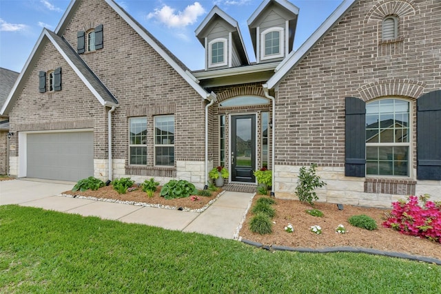 250 Peninsula Point Dr, Montgomery, TX 77356 - view of front facade featuring brick siding, concrete driveway, an attached garage, and stone siding