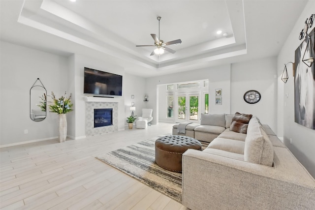 250 Peninsula Point Dr, Montgomery, TX 77356 - living room featuring a raised ceiling, ceiling fan, wood finished floors, a tiled fireplace, and recessed lighting