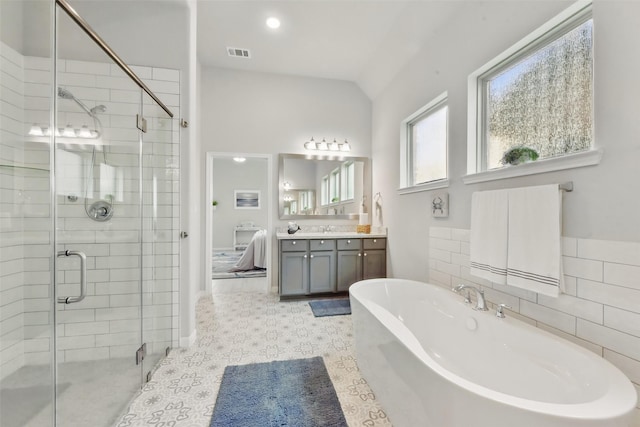 250 Peninsula Point Dr, Montgomery, TX 77356 - bathroom featuring a soaking tub, vanity, a shower stall, and vaulted ceiling