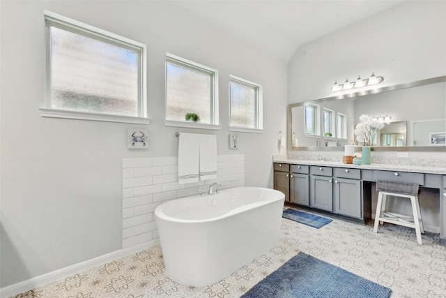 250 Peninsula Point Dr, Montgomery, TX 77356 - full bath featuring a freestanding tub, vanity, vaulted ceiling, and tile walls