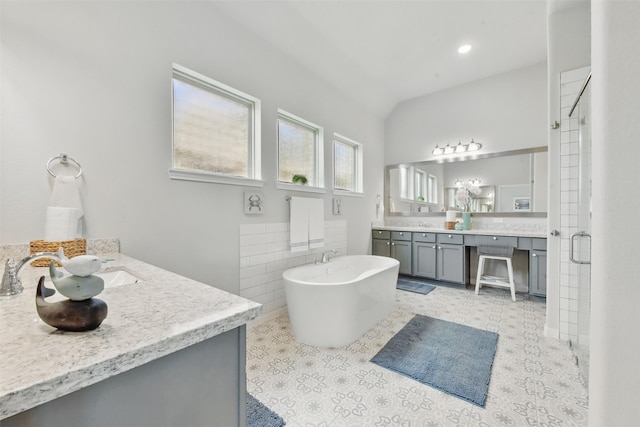 250 Peninsula Point Dr, Montgomery, TX 77356 - full bath featuring vanity, a soaking tub, a stall shower, vaulted ceiling, and tile walls