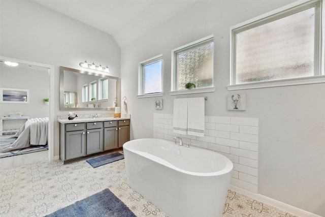 250 Peninsula Point Dr, Montgomery, TX 77356 - bathroom with vanity, a soaking tub, and vaulted ceiling