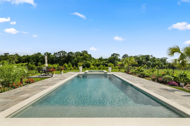 250 Peninsula Point Dr, Montgomery, TX 77356 - view of swimming pool featuring a patio area, a pool with connected hot tub, and view of wooded area