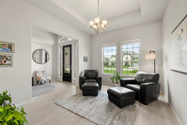 250 Peninsula Point Dr, Montgomery, TX 77356 - sitting room featuring a chandelier, light wood-style flooring, and a raised ceiling