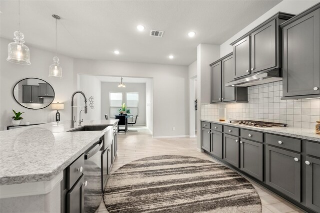 250 Peninsula Point Dr, Montgomery, TX 77356 - kitchen featuring stainless steel appliances, tasteful backsplash, light stone counters, a center island with sink, and recessed lighting