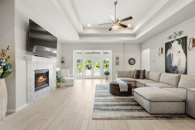 250 Peninsula Point Dr, Montgomery, TX 77356 - living area with a tray ceiling, ceiling fan, a fireplace, wood finished floors, and recessed lighting