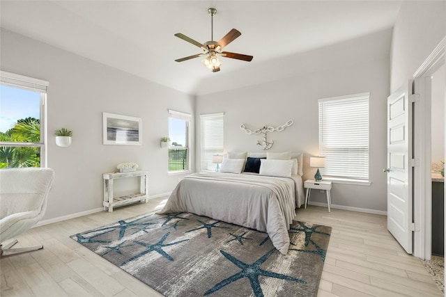 250 Peninsula Point Dr, Montgomery, TX 77356 - bedroom with light wood-style flooring, multiple windows, ceiling fan, and lofted ceiling