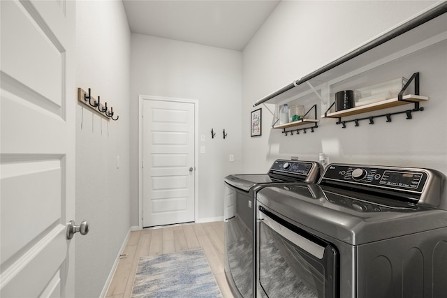 250 Peninsula Point Dr, Montgomery, TX 77356 - laundry room featuring washer and clothes dryer and light wood finished floors