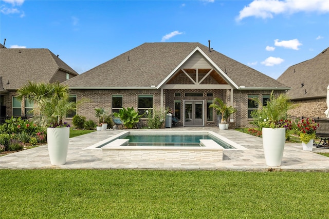 250 Peninsula Point Dr, Montgomery, TX 77356 - rear view of house featuring french doors, brick siding, an in-ground hot tub, roof with shingles, and a lawn