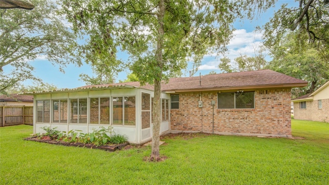110 Spruce St, Lake Jackson, TX 77566 - rear view of property featuring a sunroom and brick siding