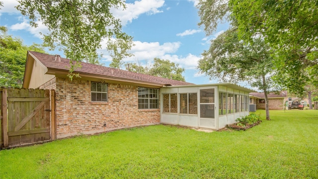110 Spruce St, Lake Jackson, TX 77566 - back of property featuring a sunroom, a gate, and roof with shingles