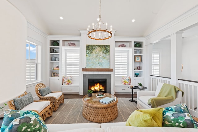 742 Positano Rd, Galveston, TX 77550 - living area with a warm lit fireplace, a chandelier, lofted ceiling, built in shelves, and wood finished floors