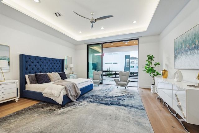 507 W Bell, Houston, TX 77019 - bedroom featuring wood finished floors, access to outside, a tray ceiling, and recessed lighting