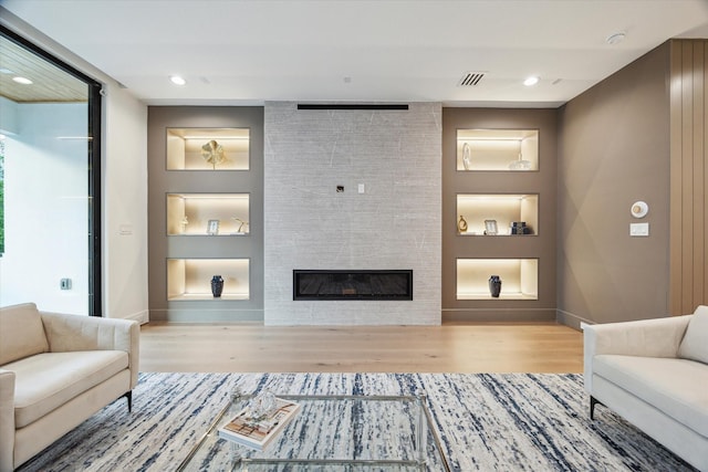 507 W Bell, Houston, TX 77019 - living area featuring wood finished floors, a tiled fireplace, and recessed lighting