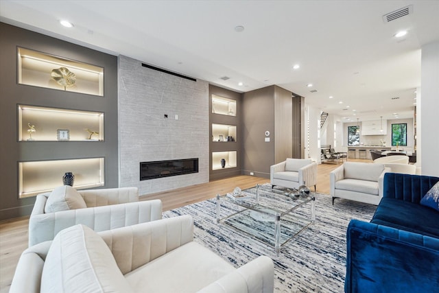 507 W Bell, Houston, TX 77019 - living area with light wood-type flooring, a fireplace, and recessed lighting