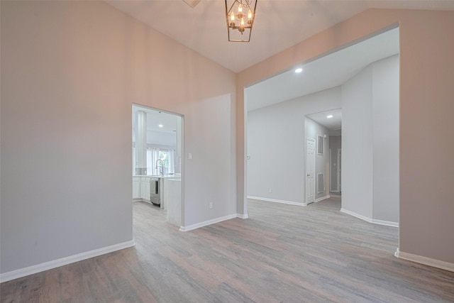 7602 Las Flores Dr, Houston, TX 77083 - spare room featuring wood finished floors, a chandelier, vaulted ceiling, and recessed lighting