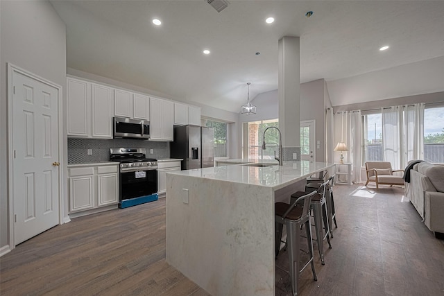 7602 Las Flores Dr, Houston, TX 77083 - kitchen with appliances with stainless steel finishes, decorative backsplash, recessed lighting, dark wood-type flooring, and white cabinetry