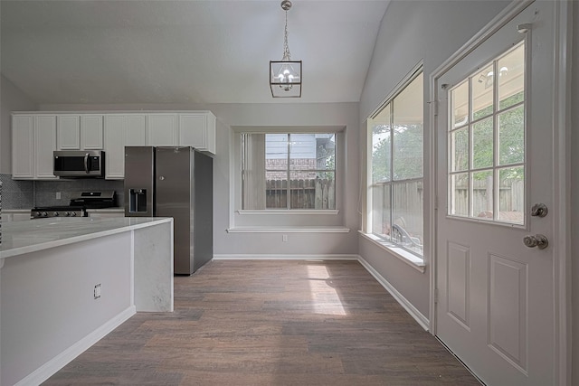 7602 Las Flores Dr, Houston, TX 77083 - kitchen with stainless steel appliances, vaulted ceiling, plenty of natural light, and white cabinets