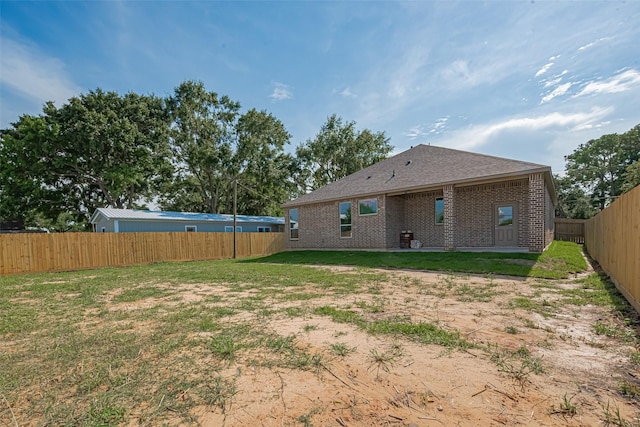3525 Federal Rd, Pasadena, TX 77504 - rear view of property featuring brick siding and a fenced backyard