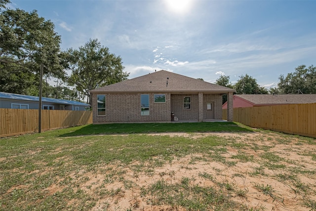 3525 Federal Rd, Pasadena, TX 77504 - rear view of property with brick siding, a fenced backyard, a patio area, and roof with shingles