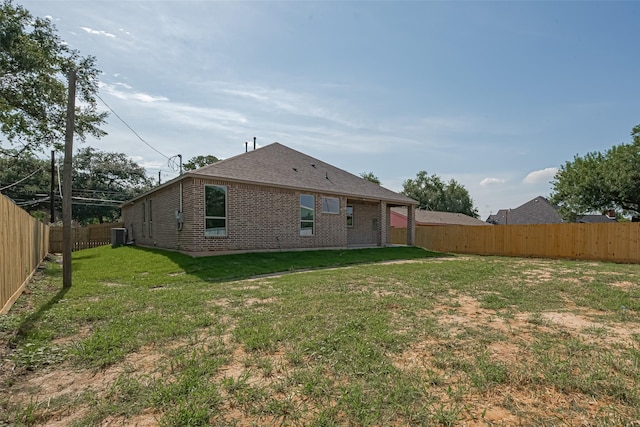 3525 Federal Rd, Pasadena, TX 77504 - rear view of house featuring a fenced backyard, brick siding, and roof with shingles