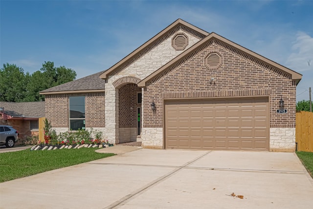 3525 Federal Rd, Pasadena, TX 77504 - french country home featuring brick siding, driveway, a garage, stone siding, and a shingled roof