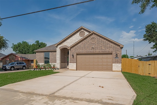 3525 Federal Rd, Pasadena, TX 77504 - french country style house featuring brick siding, stone siding, concrete driveway, and an attached garage