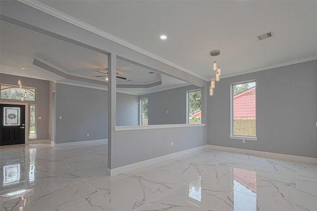 3525 Federal Rd, Pasadena, TX 77504 - spare room with a chandelier, a tray ceiling, healthy amount of natural light, light marble finish flooring, and crown molding