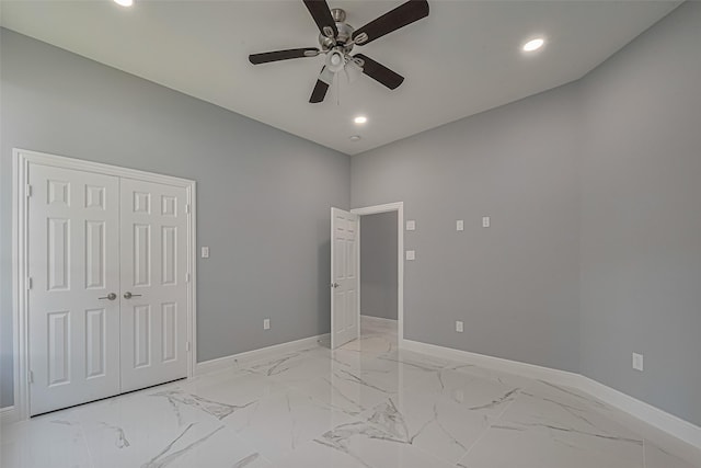3525 Federal Rd, Pasadena, TX 77504 - unfurnished bedroom featuring recessed lighting, light marble finish floors, ceiling fan, and a closet