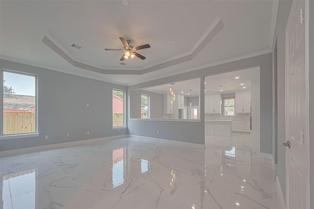 3525 Federal Rd, Pasadena, TX 77504 - empty room featuring ceiling fan, a tray ceiling, light marble finish floors, and ornamental molding