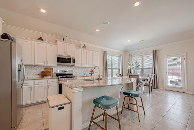 2226 Blakely Grove Ln, Richmond, TX 77469 - kitchen with appliances with stainless steel finishes, backsplash, white cabinets, recessed lighting, and ornamental molding