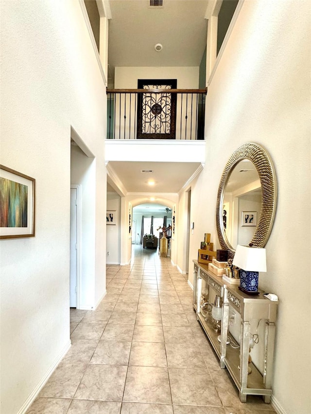 2226 Blakely Grove Ln, Richmond, TX 77469 - hall with a high ceiling, arched walkways, and light tile patterned floors