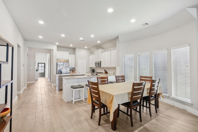 19822 Blue Roan Dr, Tomball, TX 77377 - dining space with light wood finished floors and recessed lighting