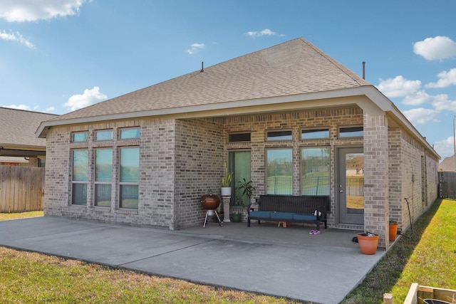 19822 Blue Roan Dr, Tomball, TX 77377 - back of house with a patio, brick siding, and a shingled roof
