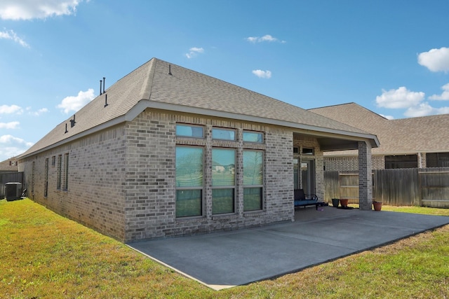 19822 Blue Roan Dr, Tomball, TX 77377 - rear view of property featuring a patio area, brick siding, and a shingled roof