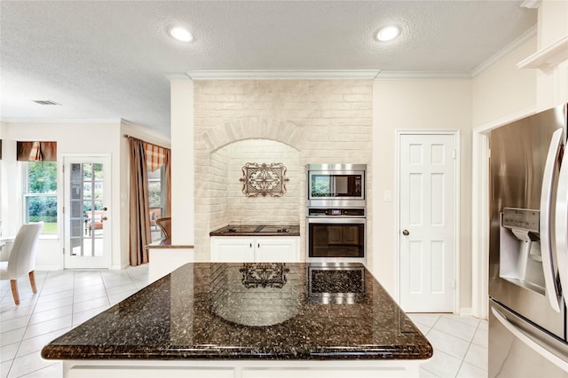 11410 Del Monte Dr, Houston, TX 77077 - kitchen with stainless steel appliances, a textured ceiling, light tile patterned floors, ornamental molding, and white cabinetry