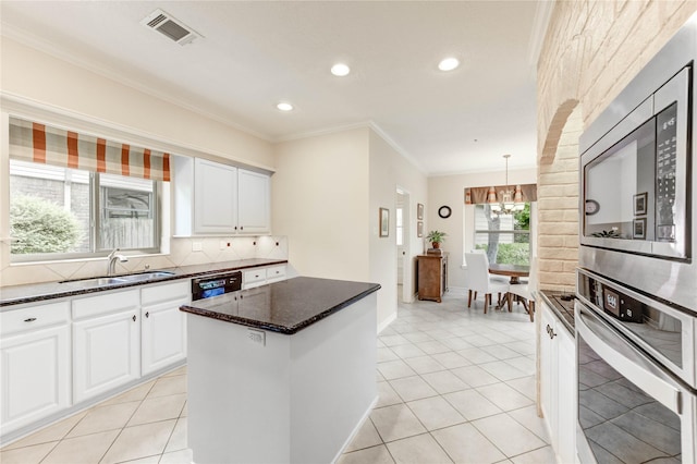 11410 Del Monte Dr, Houston, TX 77077 - kitchen featuring appliances with stainless steel finishes, a chandelier, ornamental molding, backsplash, and dark stone counters