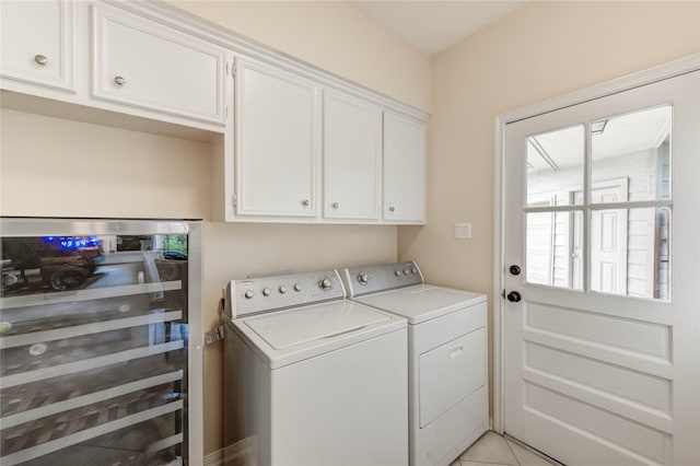 11410 Del Monte Dr, Houston, TX 77077 - laundry room with wine cooler, washer and clothes dryer, cabinet space, and light tile patterned floors