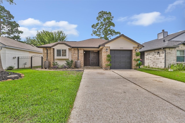 2806 Spring Dusk Ln, Spring, TX 77373 - view of front of home with a gate, concrete driveway, a front yard, an attached garage, and brick siding