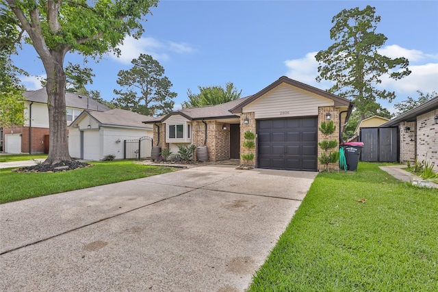 2806 Spring Dusk Ln, Spring, TX 77373 - view of front of home with brick siding, an attached garage, driveway, and a gate