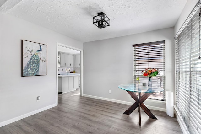 2806 Spring Dusk Ln, Spring, TX 77373 - dining area featuring a textured ceiling and wood finished floors