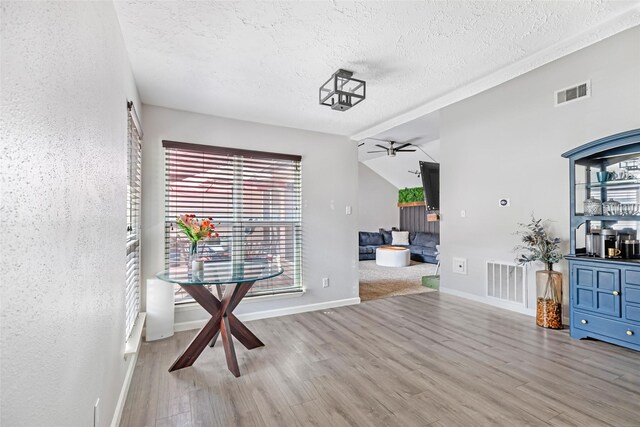 2806 Spring Dusk Ln, Spring, TX 77373 - unfurnished dining area featuring a textured ceiling, light wood finished floors, and ceiling fan