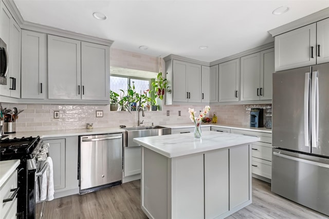 2806 Spring Dusk Ln, Spring, TX 77373 - kitchen featuring appliances with stainless steel finishes, gray cabinets, backsplash, light wood finished floors, and recessed lighting