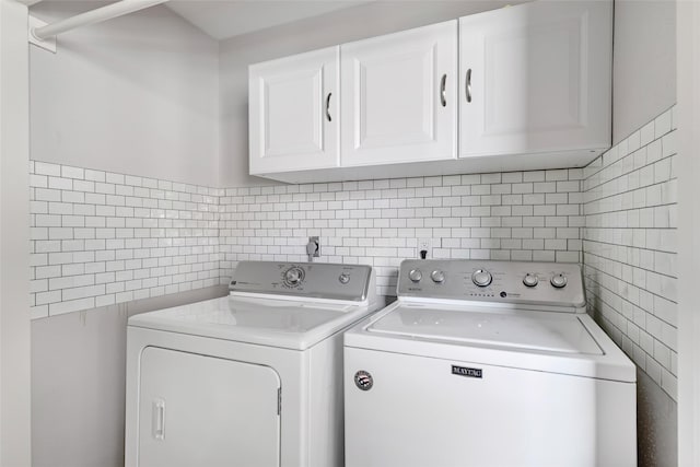 2806 Spring Dusk Ln, Spring, TX 77373 - laundry room featuring tile walls, cabinet space, and washing machine and clothes dryer