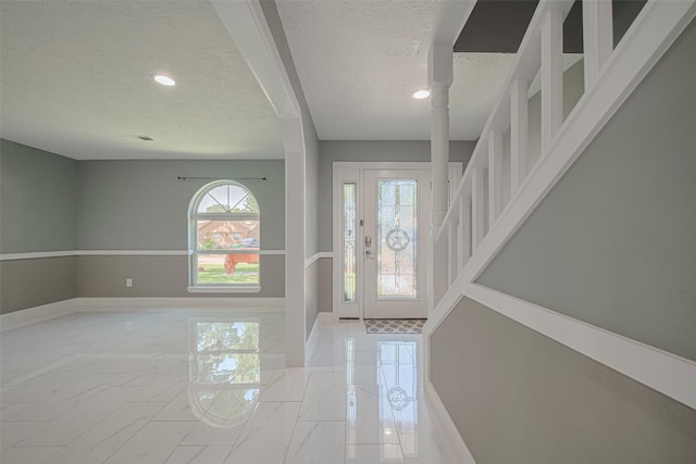 12206 Green Glade Dr, Houston, TX 77099 - entryway featuring a textured ceiling, light marble finish flooring, and recessed lighting