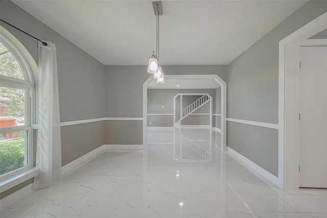 12206 Green Glade Dr, Houston, TX 77099 - unfurnished dining area with marble look tiles and baseboards